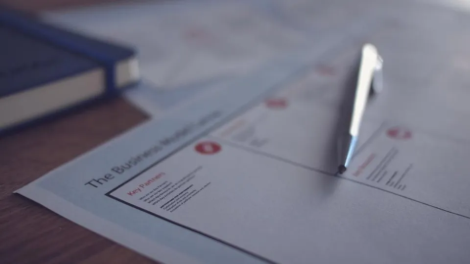 A document on a desk with a pen resting on it.